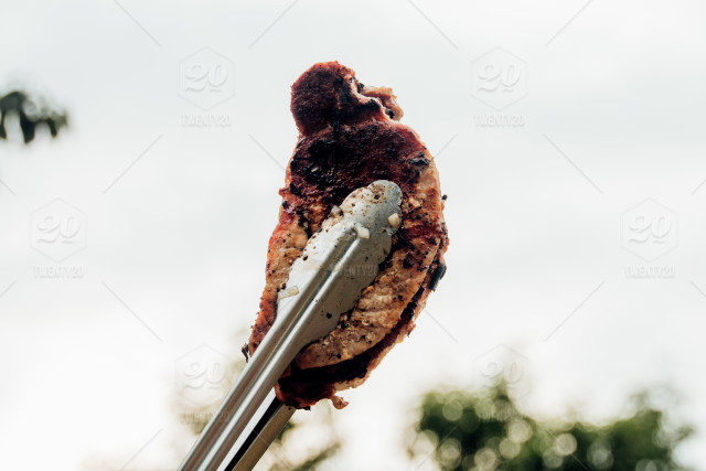 I sold Holding meat by Tongs at barbecue photo on Twenty20!Thanks!!