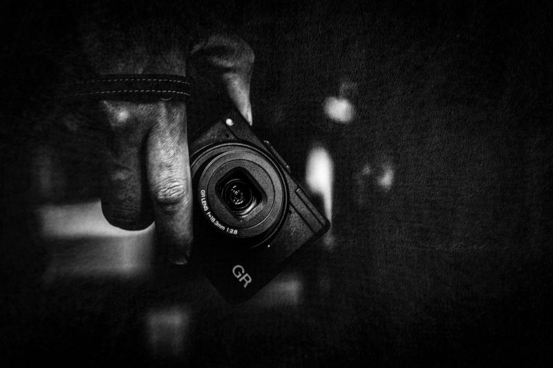Ricoh GR holding camera